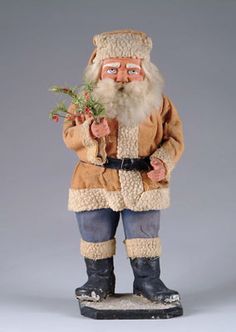 a statue of santa claus holding a plant