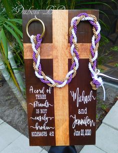 a wooden cross with two braids on it