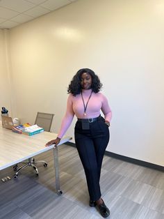 A dark skin black girl is wearing a bright pink turtleneck top on black dress pants with black loafers. Working Girl Outfits, Business Professional Outfits, Cute Work Outfits