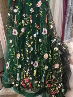 a green dress with colorful flowers on it