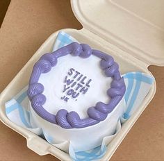 a cake in a box with the words still with you written on it's side