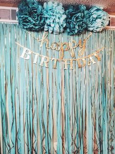 a birthday party backdrop with blue flowers and streamers