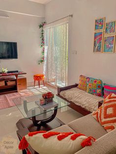 a living room filled with furniture and a flat screen tv