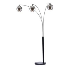 the three light floor lamp is on a black stand with two silver balls hanging from it