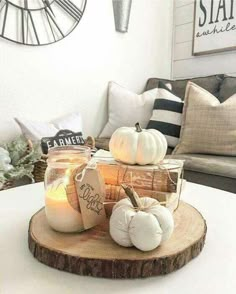 some pumpkins and candles are on a table