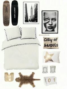 a bed room with a skateboard on the wall and pictures above it that say city of angels