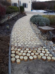 a walkway made out of wooden logs and gravel