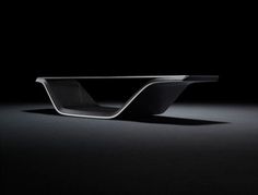 a black table sitting on top of a dark floor