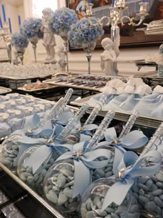 there are many blue and white items in the trays on this buffet table for sale