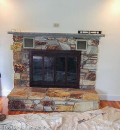 a stone fireplace in the middle of a room