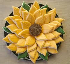 a yellow and green flower sitting on top of a wooden table