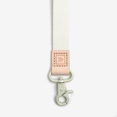 a white and pink lanyard with a metal hook