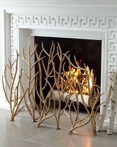 the fireplace is decorated with gold branches