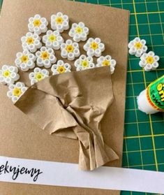 a card with some flowers on it next to a bottle of ketchup and glue