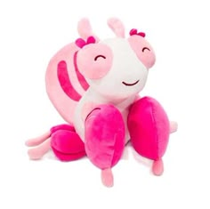 a pink and white stuffed animal sitting on the ground