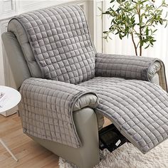 the recliner chair is covered with a quilted cover and has a remote control