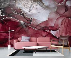 a living room with a pink couch and large painting on the wall