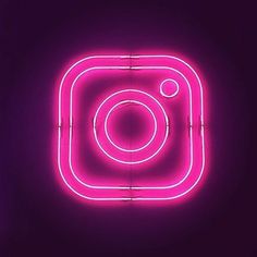 an instagram neon sign on a purple background