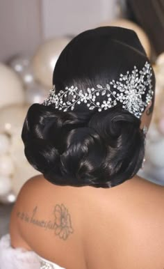 the back of a woman's head wearing a bridal hair piece