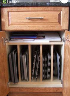 an open cabinet with many files and folders in the bottom drawer on top of it