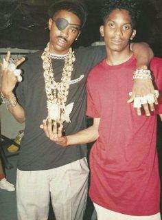 two young men standing next to each other with their hands in the shape of peace signs