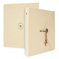 a white book with a clock on the front and back cover is open to show it's contents