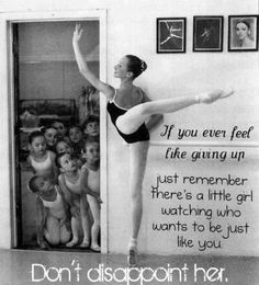 a black and white photo of a ballerina in front of a group of children