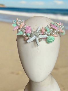 Shimmery Shells Pastel Circlet Mermaid Crown by The Head Mistress Transform into a sea diva with our Shimmery Shells Pastel Circlet Mermaid Crown by The Head Mistress! Embrace the enchanting allure of the ocean with hand-painted shells, glitter accents, bubble beads, and delicate natural moonstone chains. Main Features: Hand-painted Shells: Each shell is meticulously painted for a unique and mesmerizing look. Glitter Accents: Sparkle like the sea under the sunlight with subtle glitter detailing. Sea Witch Crown, Sea Shell Outfit, Bubble Beads, Mermaid Crown, Fabric Photography, Painted Shells, Sea Witch, A Sea, Photography Backdrops