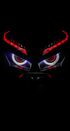 the eyes of a monster with glowing red and blue lights on it's sides