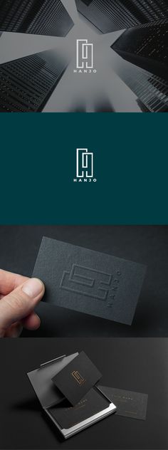 a hand holding a business card with the letter d on it and an image of a building