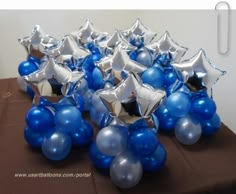 some blue and silver balloons are on a table