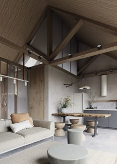 a living room filled with furniture next to a kitchen