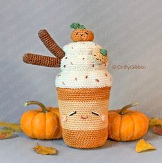 a crocheted cupcake with two pumpkins on top and one in the shape of an ice cream cone