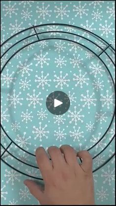 someone is pointing at the bottom of a glass plate with snowflakes on it