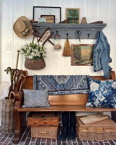 a wooden bench sitting under a shelf filled with hats