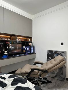 a chair and ottoman in a room with a cow print rug on the floor next to it