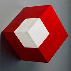 a red and white object is hanging on the wall