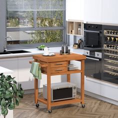 a kitchen with an island and wine rack in the center, next to a window