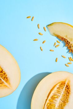 sliced melon and seeds on blue background