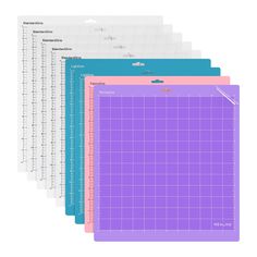 five pieces of purple and blue cutting mat with rulers on each side, all in different colors