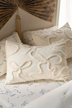 two white pillows sitting on top of a bed