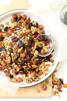 a white plate topped with nuts and raisins