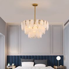 a bedroom with a large bed and a chandelier hanging from it's ceiling