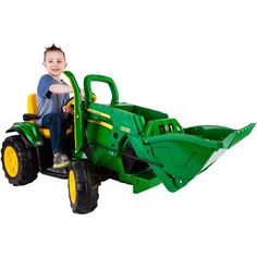 a young boy riding on the back of a green tractor