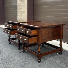 two wooden drawers sit on top of each other in front of a garage door,