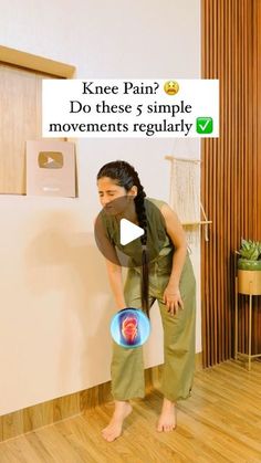 a woman holding a frisbee in her right hand while standing next to a wall