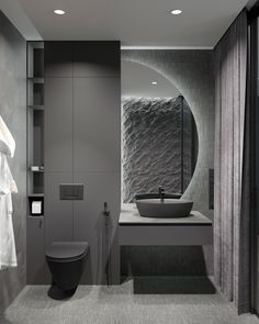 a bathroom with a sink, toilet and shower stall in it's center area