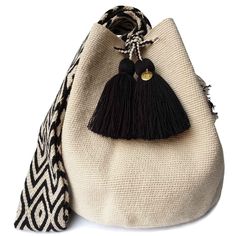 a black and white bag with a tasselled handle