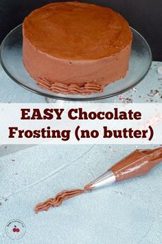 a chocolate frosted cake sitting on top of a table next to an empty knife