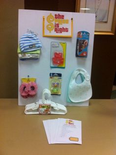 a baby's items are displayed on the table in front of a sign that says,